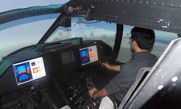 Ilker Oruc, doctoral candidate in aerospace engineering, approaches a frigate in an SH-60 helicopter in the VLRCOE Fixed-base Flight Simulator Lab.