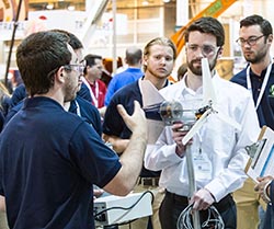 Pat Nicodemus, industrial engineering junior, and Mitch Proulx, mechanical engineering junior, discuss the Penn State team's wind turbine design with Collegiate Wind Competition judges.