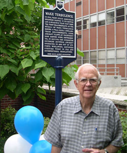 Barney McCormick in front of the wake turbulence historical marker, erected to commemorate the first measurements of the details of wake turbulence behind a full-scale airplane.