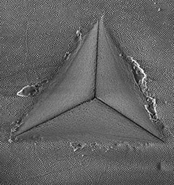 A nano-porous anodic aluminum oxide membrane after nanoindentation showing shear banding behavior around an indentation impression