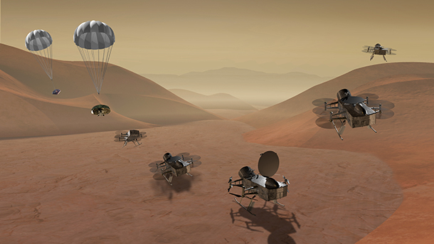 The Dragonfly dual-quadcopter, shown here in an artist’s rendering, would land on Saturn’s moon Titan and then make multiple flights to explore diverse locations as it characterizes the habitability of the ocean world’s environment. On Dec. 20, Dragonfly was chosen as a finalist for NASA’s New Frontiers program. Credit: APL/Steve Gribben