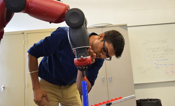 Aerospace engineering Ph.D. student Mollik Nayyar calibrates a robot to play an interactive game in the Robot Ethics and Aerial Vehicles Laboratory.