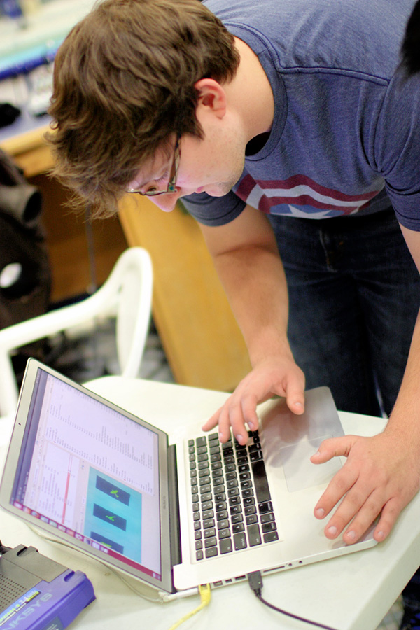 [Photo] Daniel changes controller parameters at the pool during a test on Feb. 24, 2015.